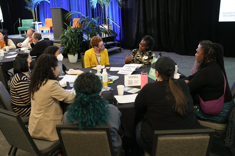 A table of people workshopping at the conference.